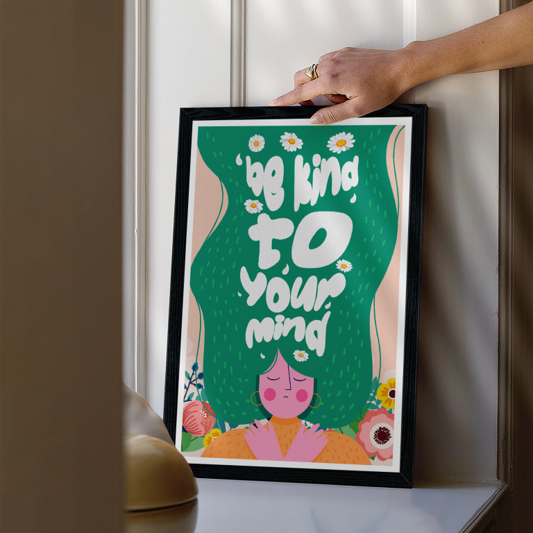 Be Kind to Your Mind print framed above a bed