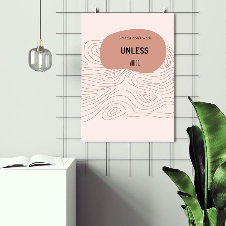 Dreams Don't Work Unless You Do print framed above a desk