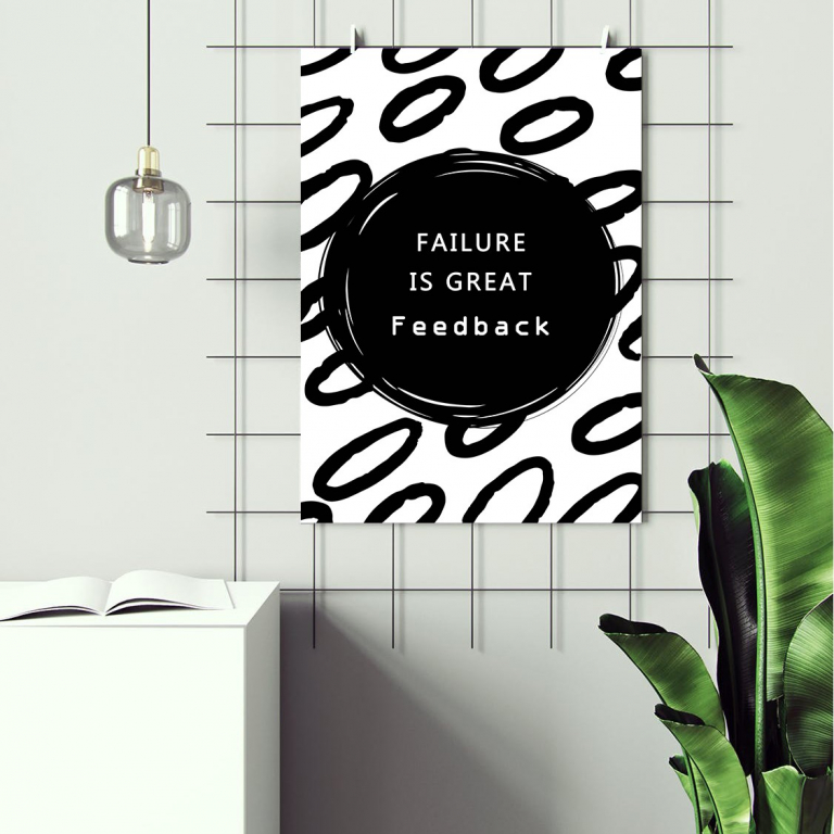 Failure Is Great Feedback print framed above a desk