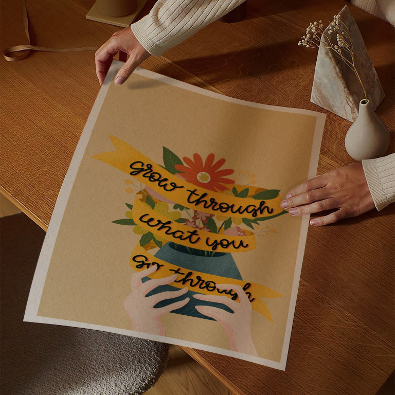 Grow Through print framed above a bed