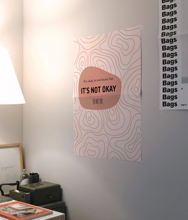 It's Not Okay to Give Up print framed above a desk